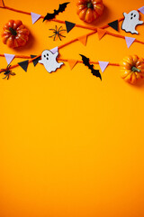 Halloween border with pumpkins, spiders, ghosts, and bats on an orange backdrop. Perfect for seasonal promotions, party invitations, and holiday-themed designs
