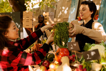Female consumer at a farmers market counter, choosing fresh, locally grown organic produce. Vendor...