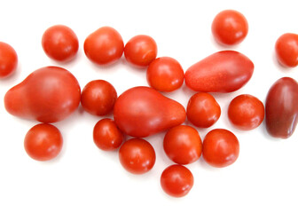 Mini black, red, and yellow tomatoes isolated on white