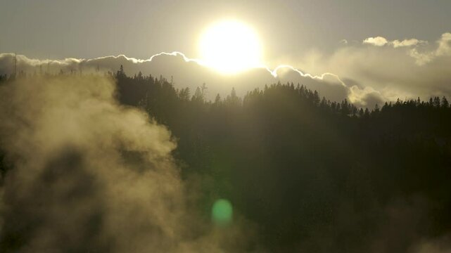 Cinematic shot of backlit sunset at Norris Geyser Basin in Yellowstone National Park, USA