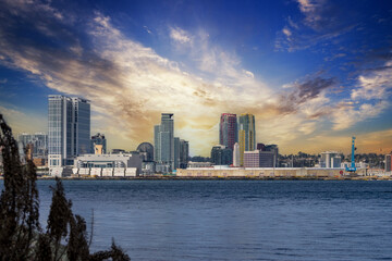 Fototapeta premium skyscrapers, office buildings, the San Diego Convention Center and cranes along the coast of the San Diego Bay at Coronado Tidelands Park in Coronado California USA