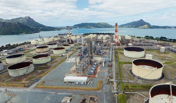 Chimney stacks and storage tanks at the decommisioned Marsden Point Refinery, Whangarei, Northland, New Zealand.