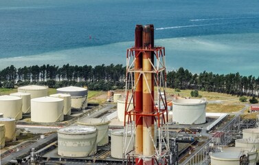 Chimney stacks and storage tanks at the decommisioned Marsden Point Refinery, Whangarei, Northland,...
