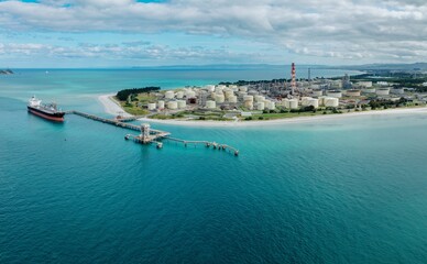 Petroleum tanker and storage silos at the decomissioned Marsden Point Refinery, Whangarei, Northland, New Zealand.