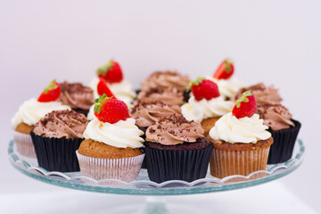 Candy bar at celebration party. Close up of sweets, cakes, pastries, muffins with strawberries.