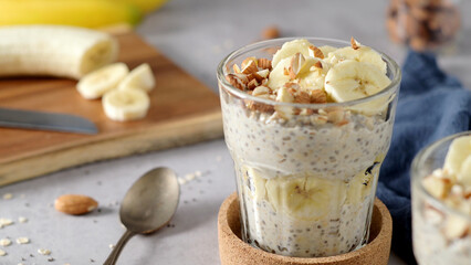 Two bowls of overnight oats topped with banana slices and almonds