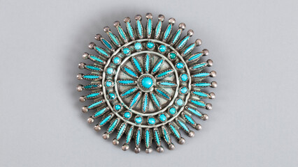 Big old blue brooch with American turquoises in silver. Isolated handmade jewelry, flat lay, close...