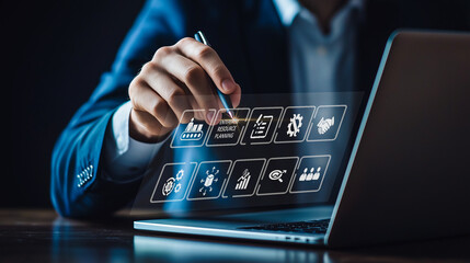 A businessman uses a futuristic interface to manage Enterprise Resource Planning (ERP), symbolizing the integration of complex business processes through advanced digital systems.