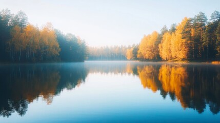 Fototapeta premium A serene autumn sunset over a tranquil lake, where warm colors reflect beautifully on the calm water's surface. The rich hues of orange, pink, and purple create a breathtaking scene 