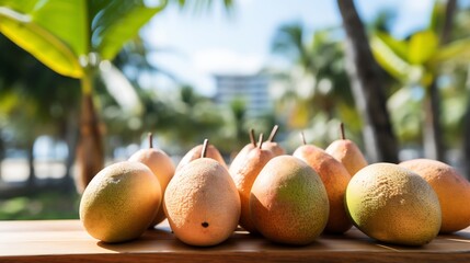 Mamey sapote fruits scattered across colorful outdoor caf table beachside restaurant surfboards sun umbrellas softly blurred behind evoking lively laidback summer vibe Scientific name Pouteria sapota