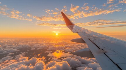 Obraz premium Airplane Wing Above Clouds at Sunset