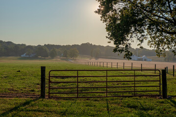 Pasture gate is closed at sunrise