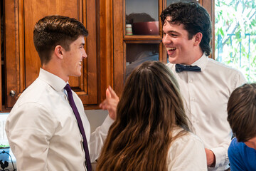 Young adults engage in lively conversation at a social gathering in a home setting during the afternoon