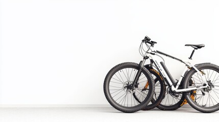 Obraz premium Two Modern Mountain Bikes Leaning Against a Minimalist White Wall in a Bright Room