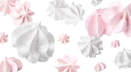 Delicious meringue cookies in air on white background