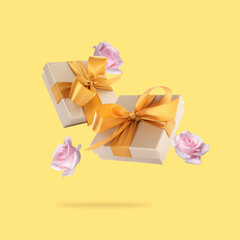 Gift boxes and roses in air on pastel yellow background