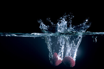 Red pepper in water with splashes