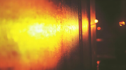 Abstract Yellow and Orange Blurred Lights Through Water Droplets on Glass