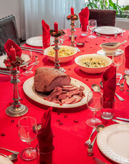 Sweden Ham on a Christmas Dinner Table with Red Tablecloth