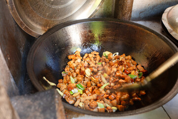 Braised pork stewed in a large iron pot