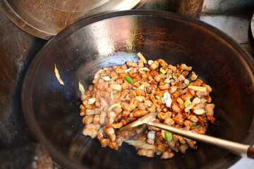 Braised pork stewed in a large iron pot