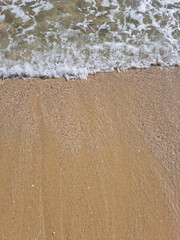 
It is a sandy beach with waves rolling in.