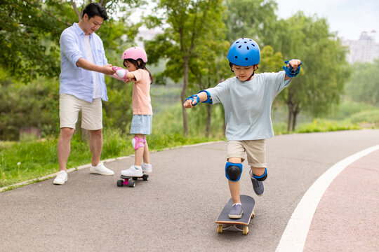 Kids Skateboarding With Dad
