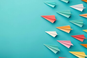 Colorful paper airplanes flying on a turquoise background, representing creativity, innovation, and adventure The vibrant shades of pink, orange, white, green, and blue create an engaging visual con
