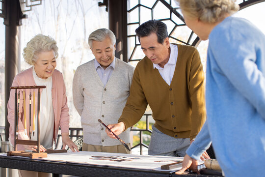 Senior Friends Practicing Chinese Calligraphy