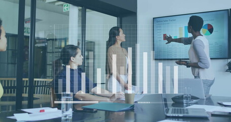 Bar graph image over business meeting with diverse team analyzing sales data