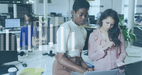 Obraz premium Analyzing data charts image over diverse businesswomen collaborating in office