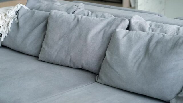 close-up of a gray sofa with pillows
