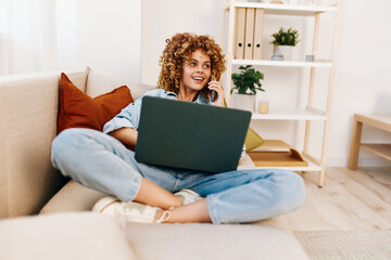 Smiling Woman Freelancer Typing on Laptop in Cozy Living Room