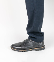 Close-up of Men's Formal Shoes and Trousers on a White Background