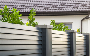 Modern stone fence with aluminum or metal shutter
