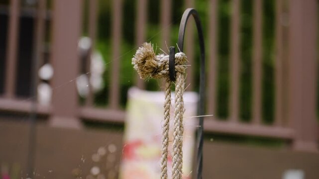 Artfully crafted bells acting as wind chimes in a garden.