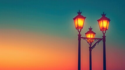 Warm gradient background from yellow to coral, worm's-eye view of vintage street lamps against dusk sky, space for text