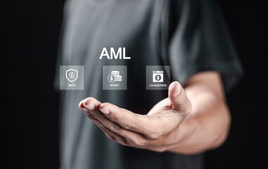 AML, Anti money laundering financial bank concept, Person holding AML icons on virtual screen for...