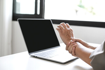 Woman hand with wrist pain numbness and pain in the palm of the hand has pain and tingling in the nerve endings This is a side effect of sitting and working for a long time on a laptop at the office