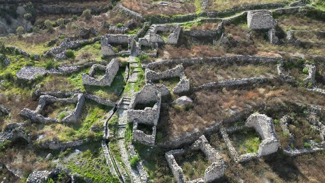 Flyover old stone building ruins of Uyo Uyo cemetery in southern Peru