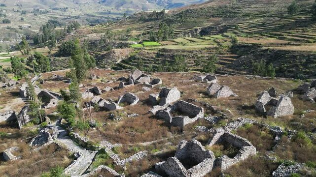 Flyover Uyo Uyo ruins toward terraced agriculture hillsides beyond