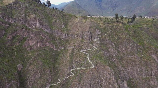 Aerial: Switchback footpath trail leads into steep Colca Canyon, Peru