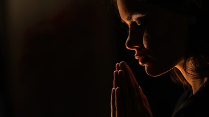 Christ religion and christianity worship or pray concept. Christian catholic woman are praying to god in dark at church.