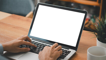 Mockup laptop computer. hand man work using laptop with white background for advertising,contact business search information on desk at coffee shop.marketing and creative design