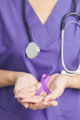 Doctor holding purple Ribbon for Violence, Pancreatic, Esophageal, Testicular cancer, Alzheimer,...
