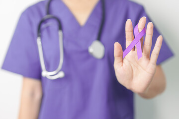 Doctor holding purple Ribbon for Violence, Pancreatic, Esophageal, Testicular cancer, Alzheimer,...