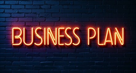 Obraz premium business plan word lettering glowing with neon light on dark brick wall background