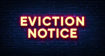 Fototapeta premium eviction notice word lettering glowing with neon light on dark brick wall background