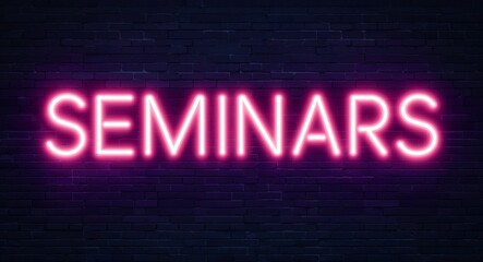 Obraz premium seminars word lettering glowing with neon light on dark brick wall background