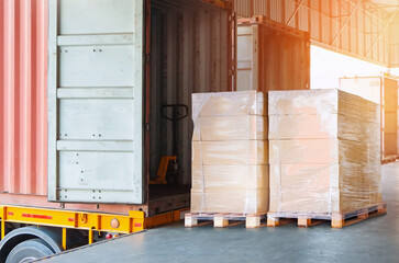 Bulk Pallets of Packaging Boxes Being Loaded onto a Container Trucks. Distribution Warehouse Container Transport, Supply chain, Parcel Delivery. Freight truck, Logistics, Transportation.